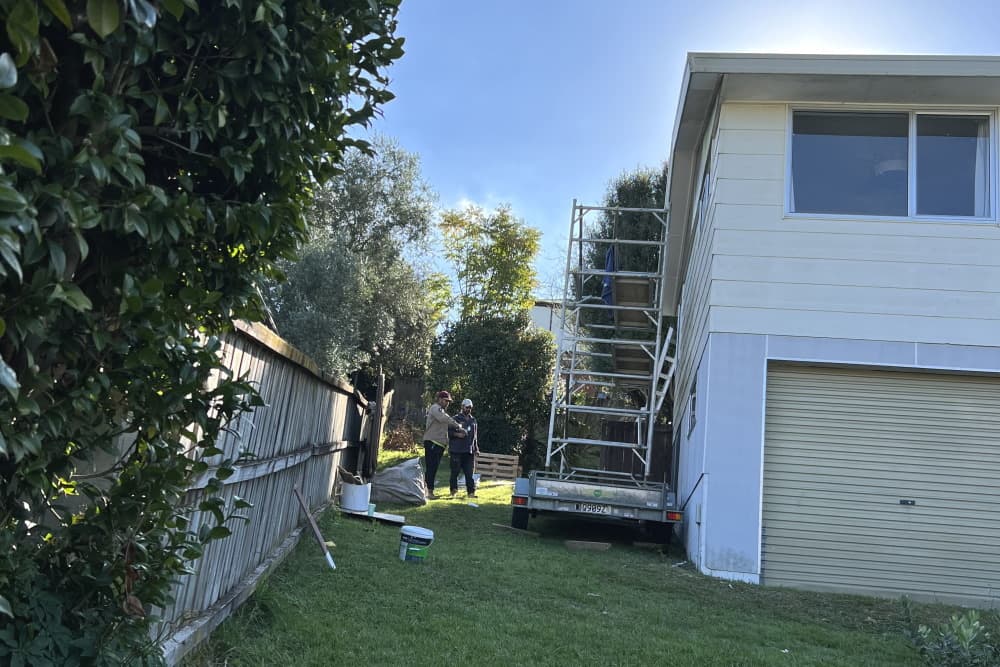 Two team members preparing to work on residential property soffits and cladding, links to soffits and cladding page.