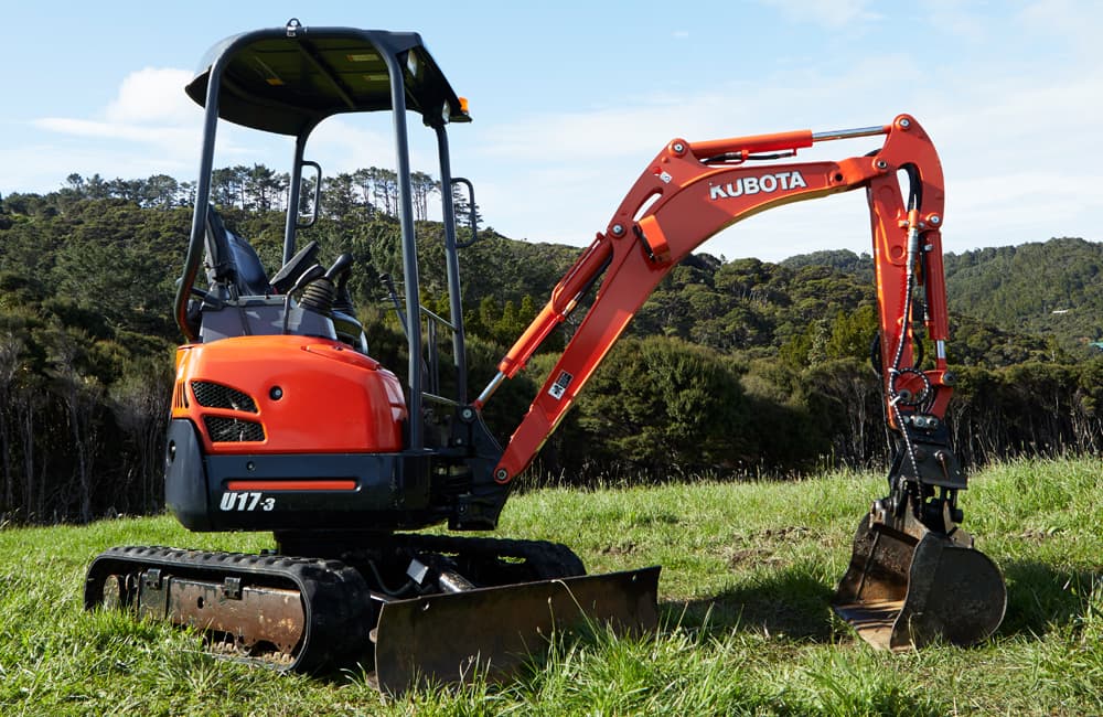 Mini orange digger with a bucket for excavating small amounts of dirt