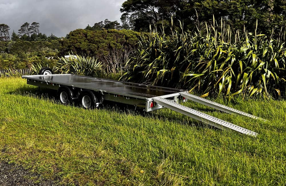 Long A-frame trailer with a platform perfect for moving heavy machinery and slightly smaller tiny homes