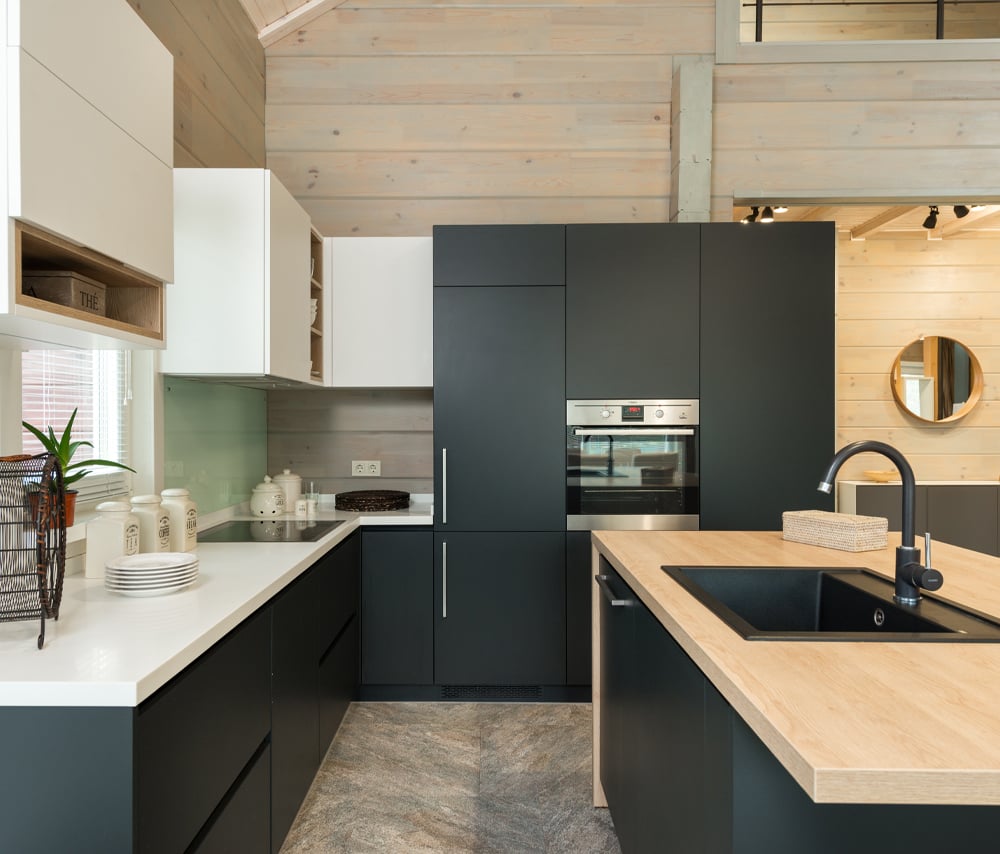 Classic black cabinetry with a white bench top, wood island top and an in-built oven