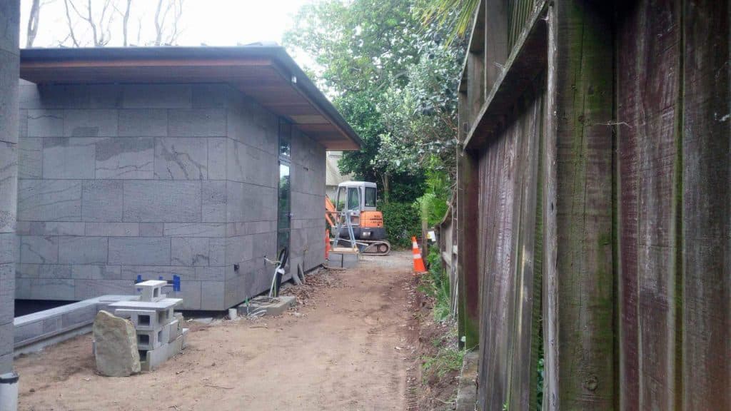  Newly built home with an excavated side lawn being prepared for new soil and grass