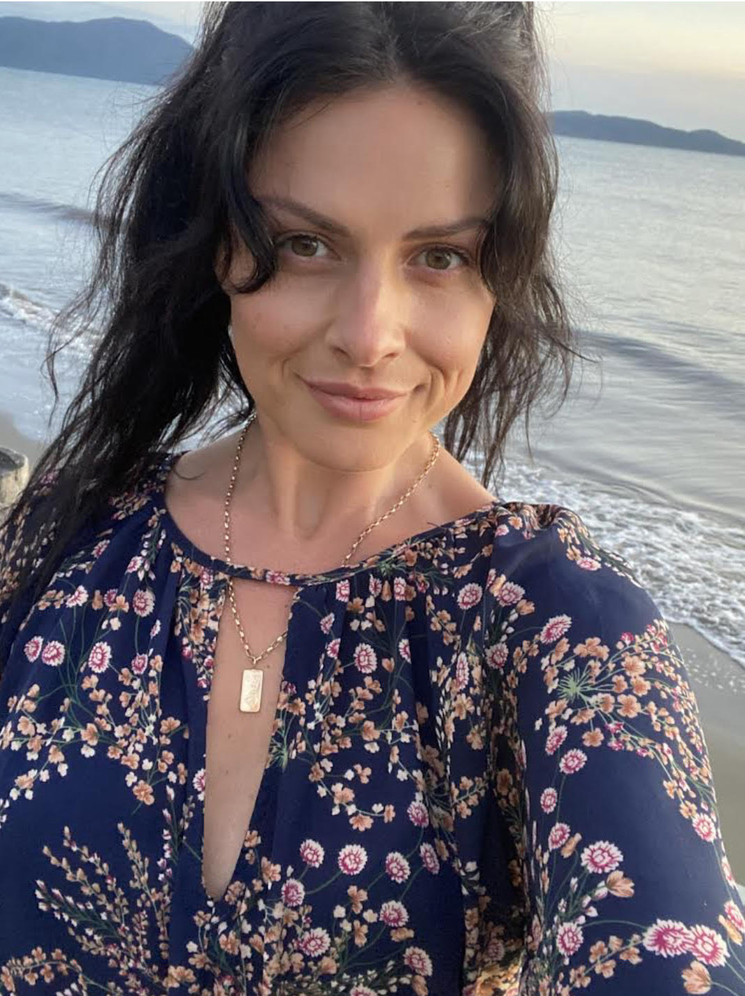 Pretty Good Facial’s founder, Megan Calkin on the Kapiti Coast beach showing off her flawless skin