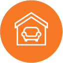 White icon of house interior in an orange circle