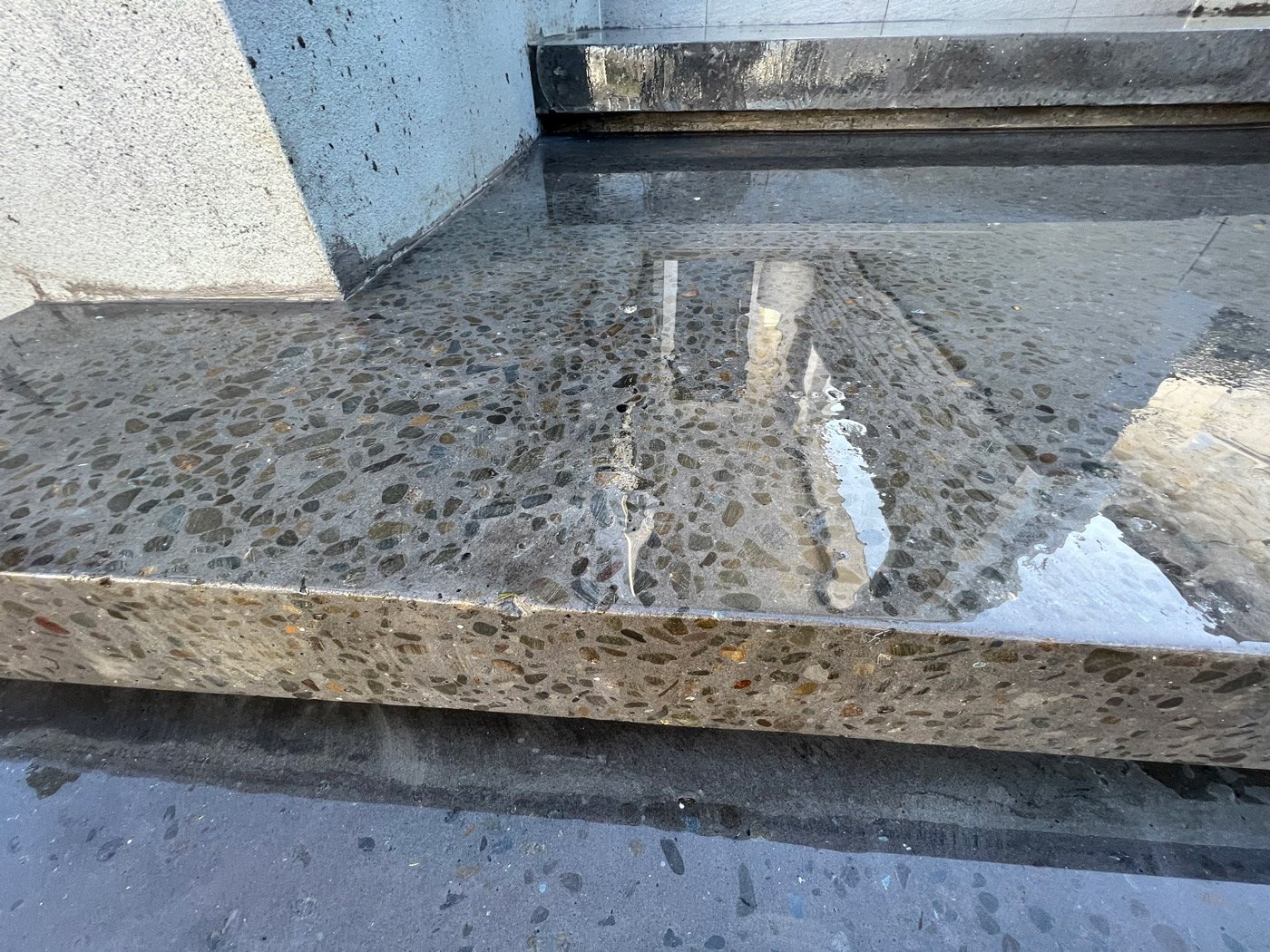Close up of a wet freshly cleaned concrete step