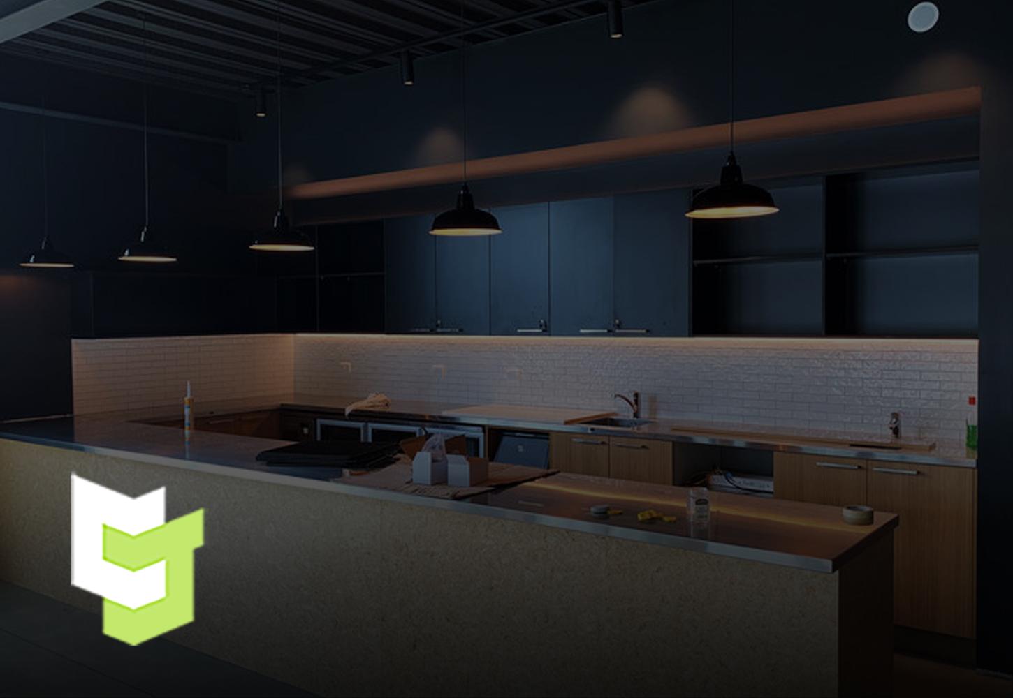 NZMA industrial kitchen space with sleek black hanging lights and a mixture of black and oak coloured wooden cabinetry 