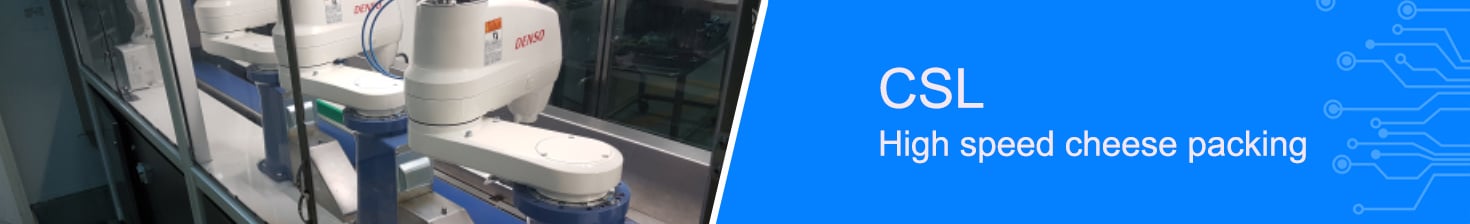 Large white automated industrial machines lifting product on to a factory conveyor belt 