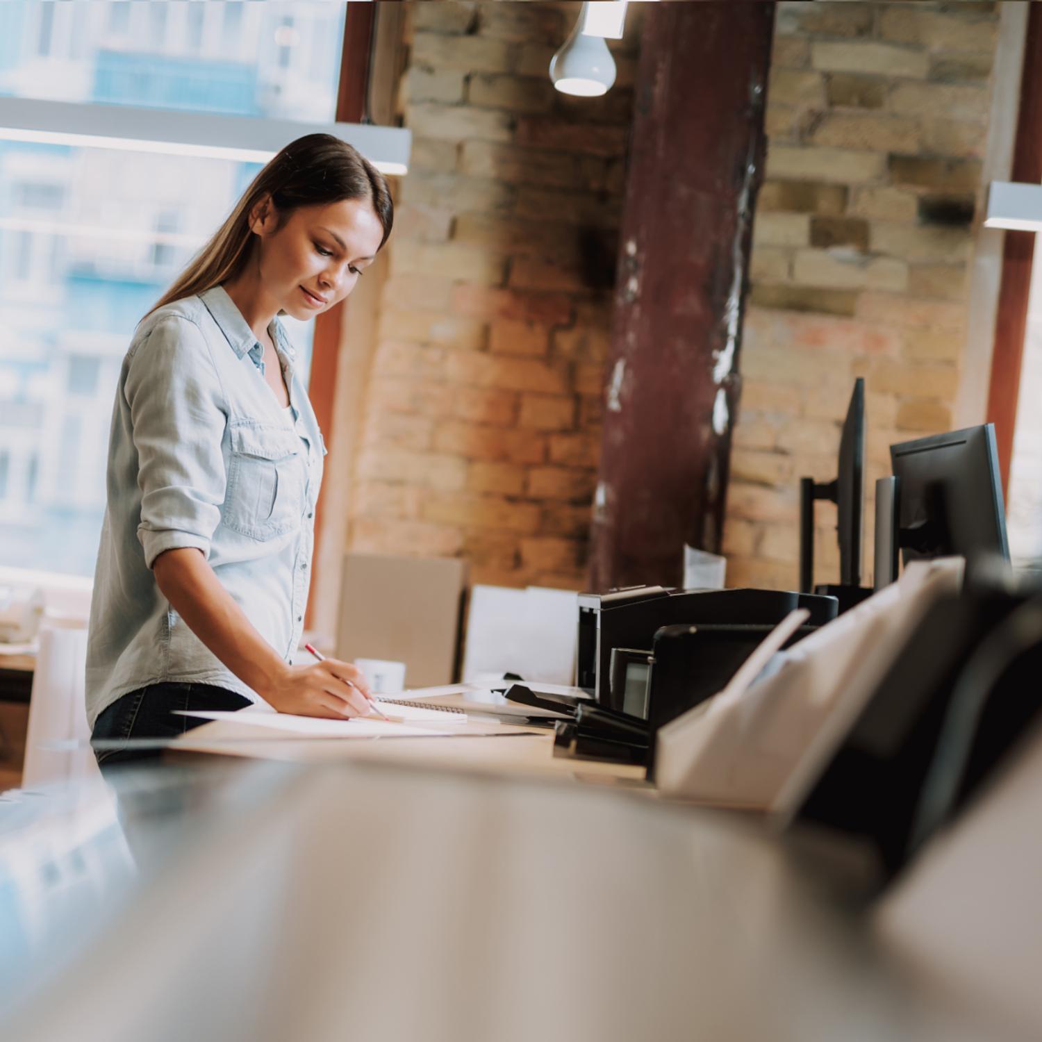 woman in office with printer/copier