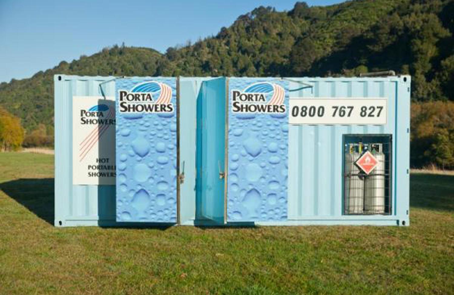 Porta Showers portable container unit showers, painted in blue and heavily branded with Porta Showers signage