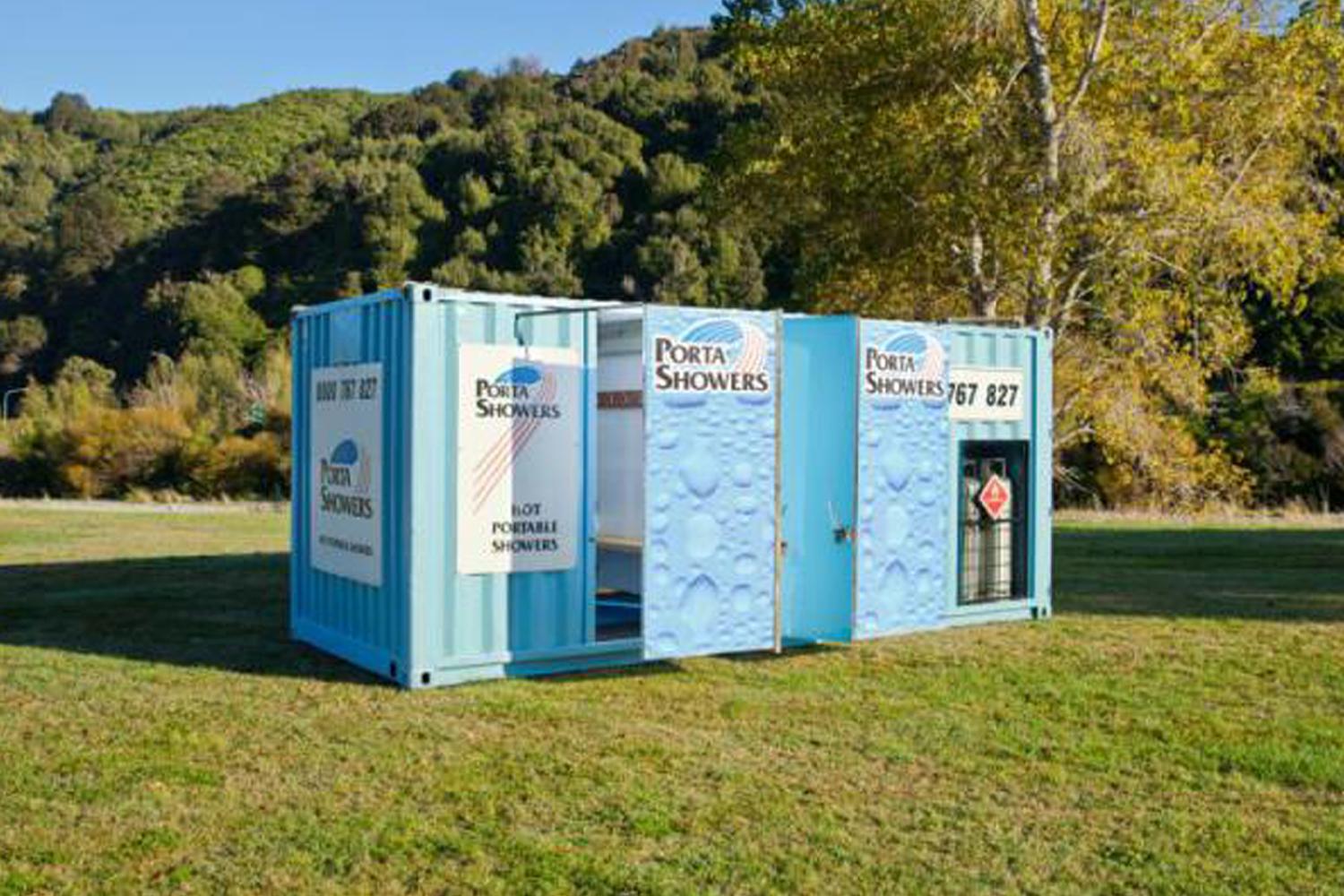 Porta Showers portable container unit showers, painted in blue and heavily branded with Porta Showers signage