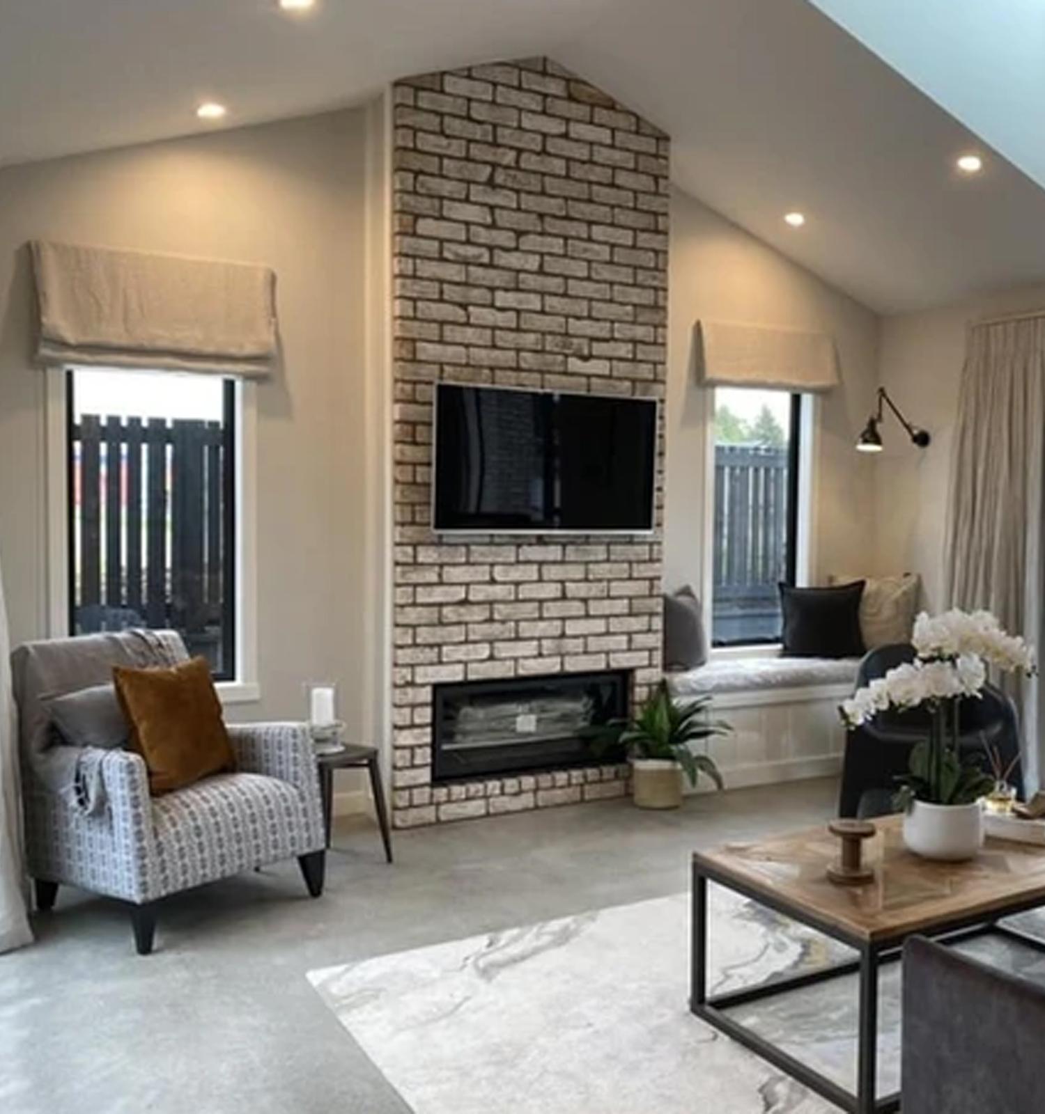 Residential interior with white walls and a white brick feature wall and cosy furnishings