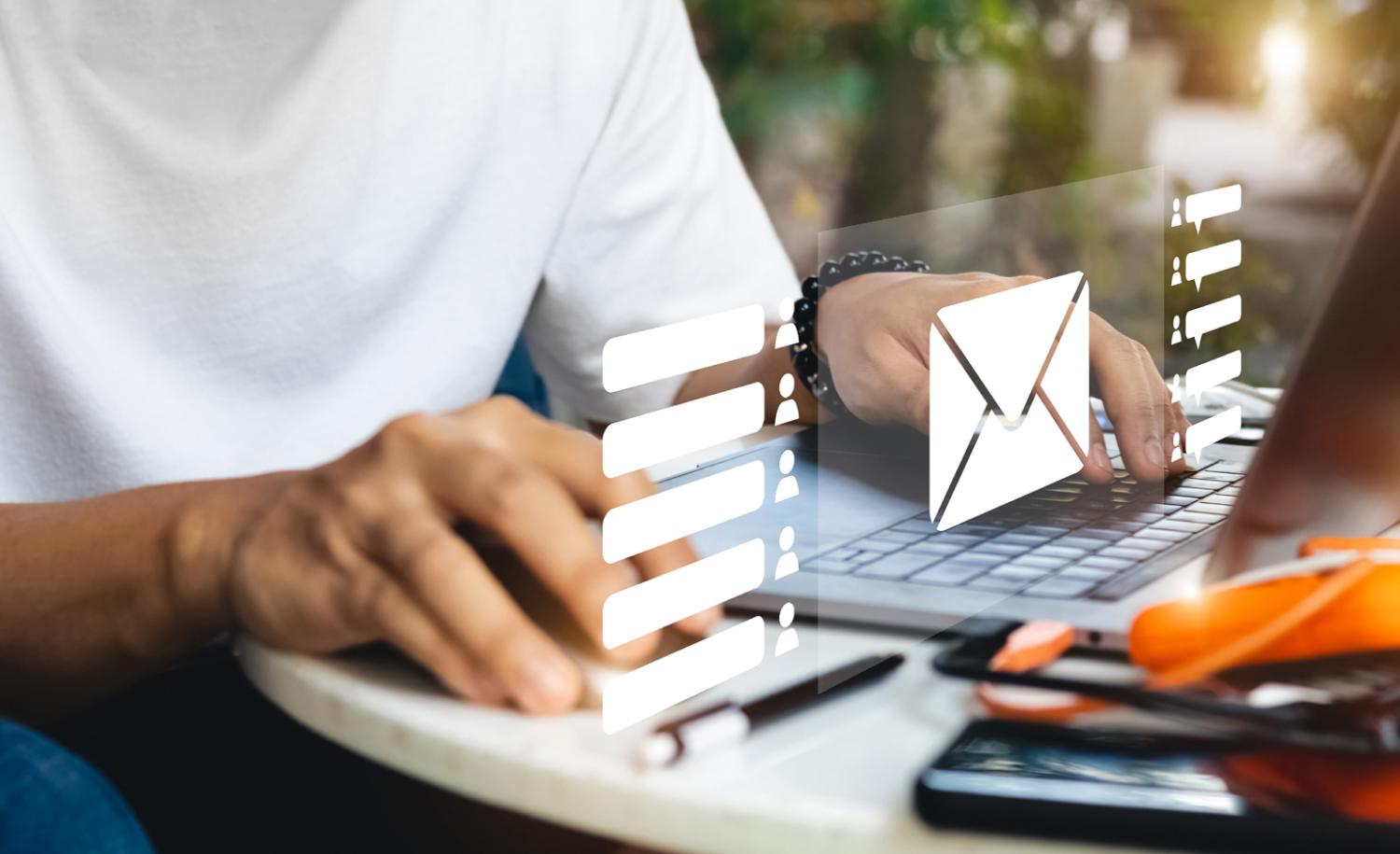 Close up of person with their hands on a keyboard and mouse preparing to send an Enewsletter