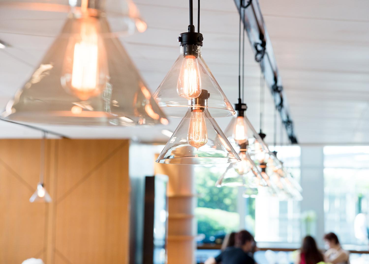 A row of hanging Black and glass pendant lights Installed by a Master Electrician