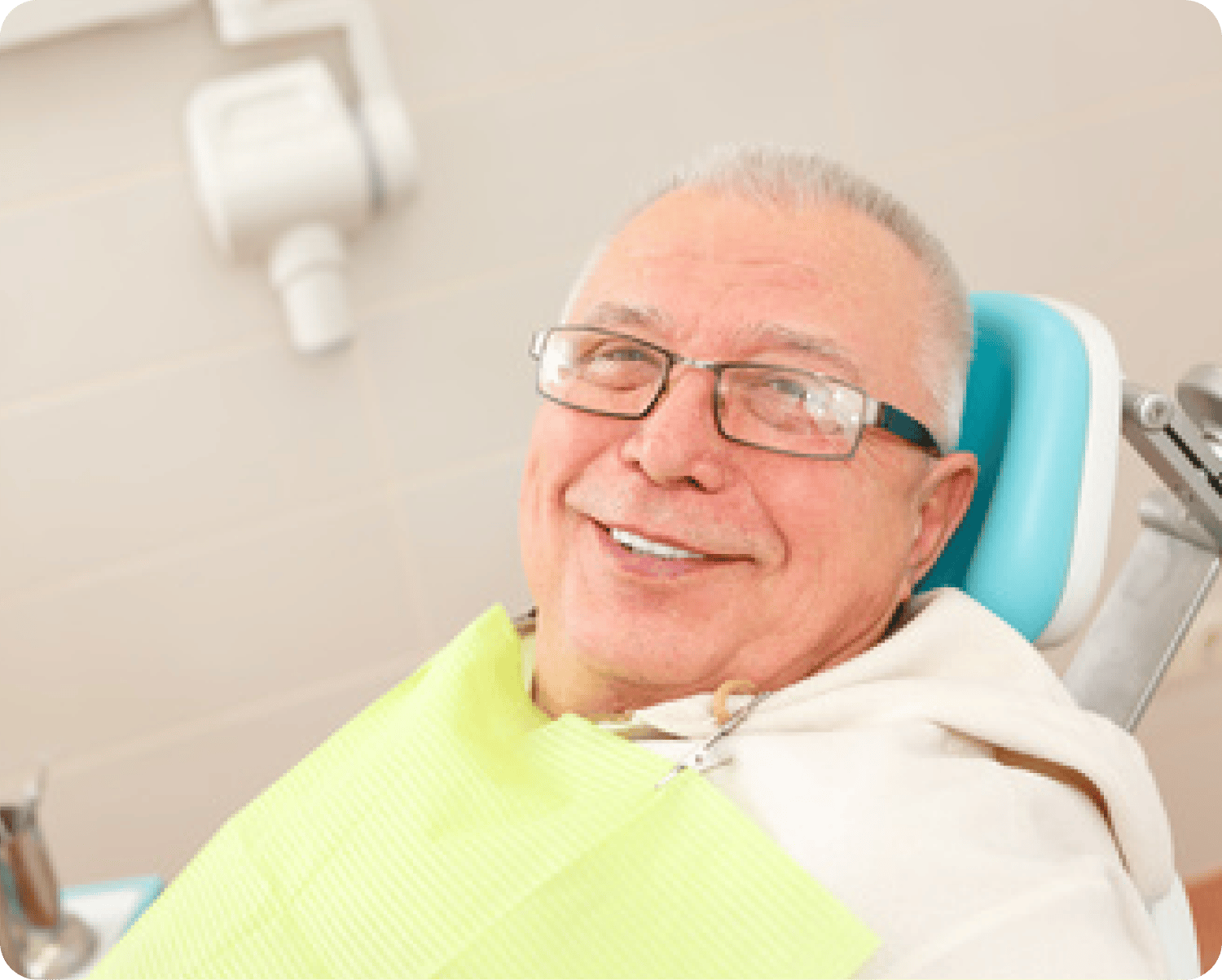 Man sitting in Dentist chair smiling
