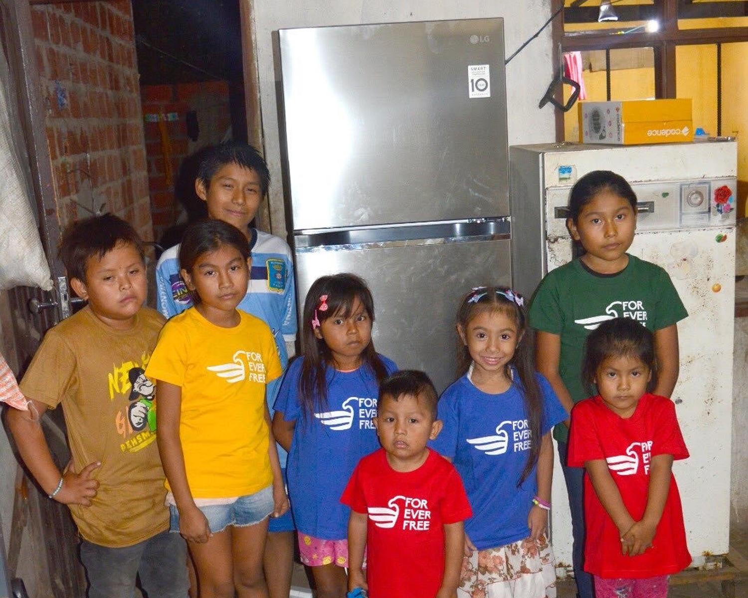 Children with new fridge donated by ForeverFree, Santa Cruz, Bolivia