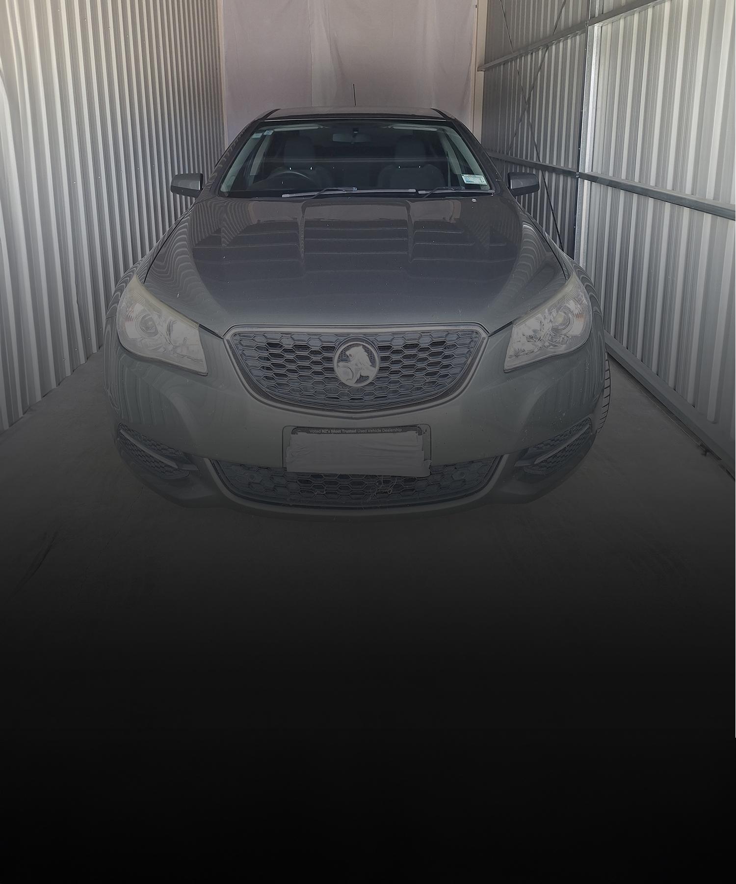 The front of a Silver Medium sized car parked inside one of the Storage Units | Links to the 'What We Do' page