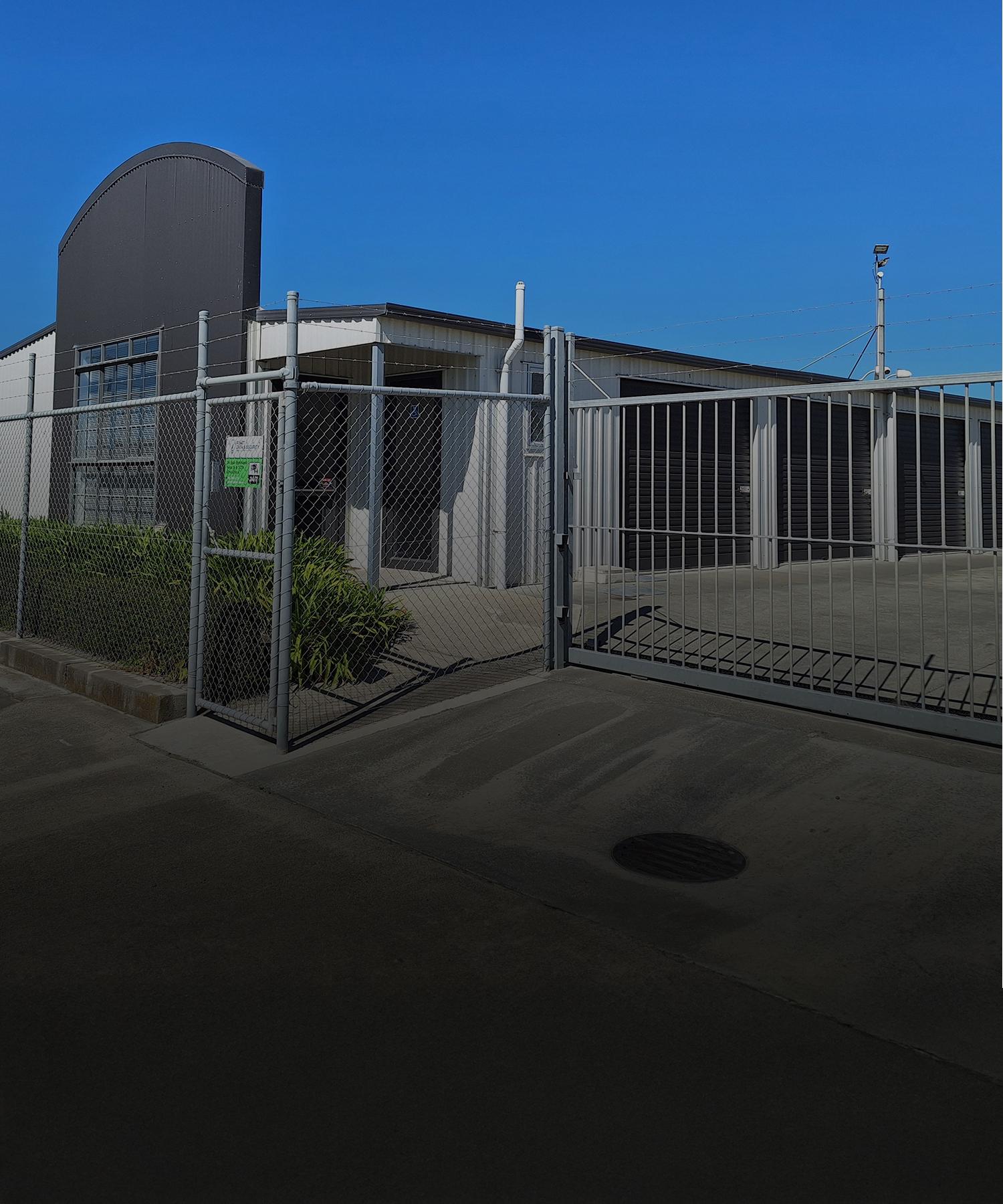Image outside the front gate of the Five Star Self Storage Facility with secure fencing and barbed wire on top | Links to the 'Our Facility' page Gallery