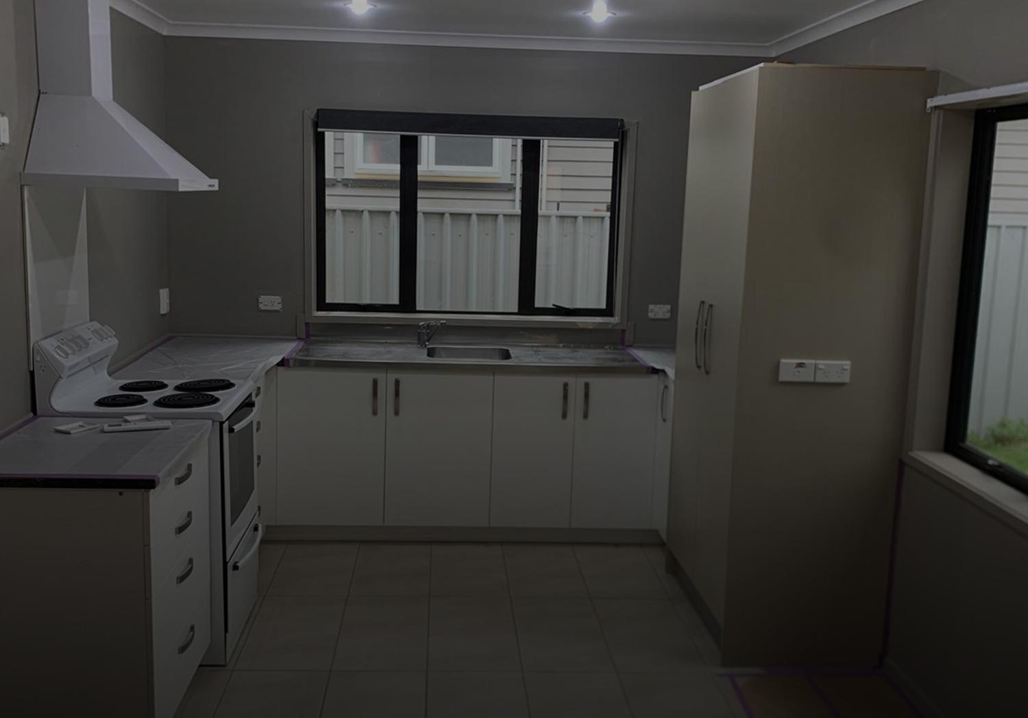 Three male painters pictured inside a home that is currently having the interior re-painted | Links to the Decorating page