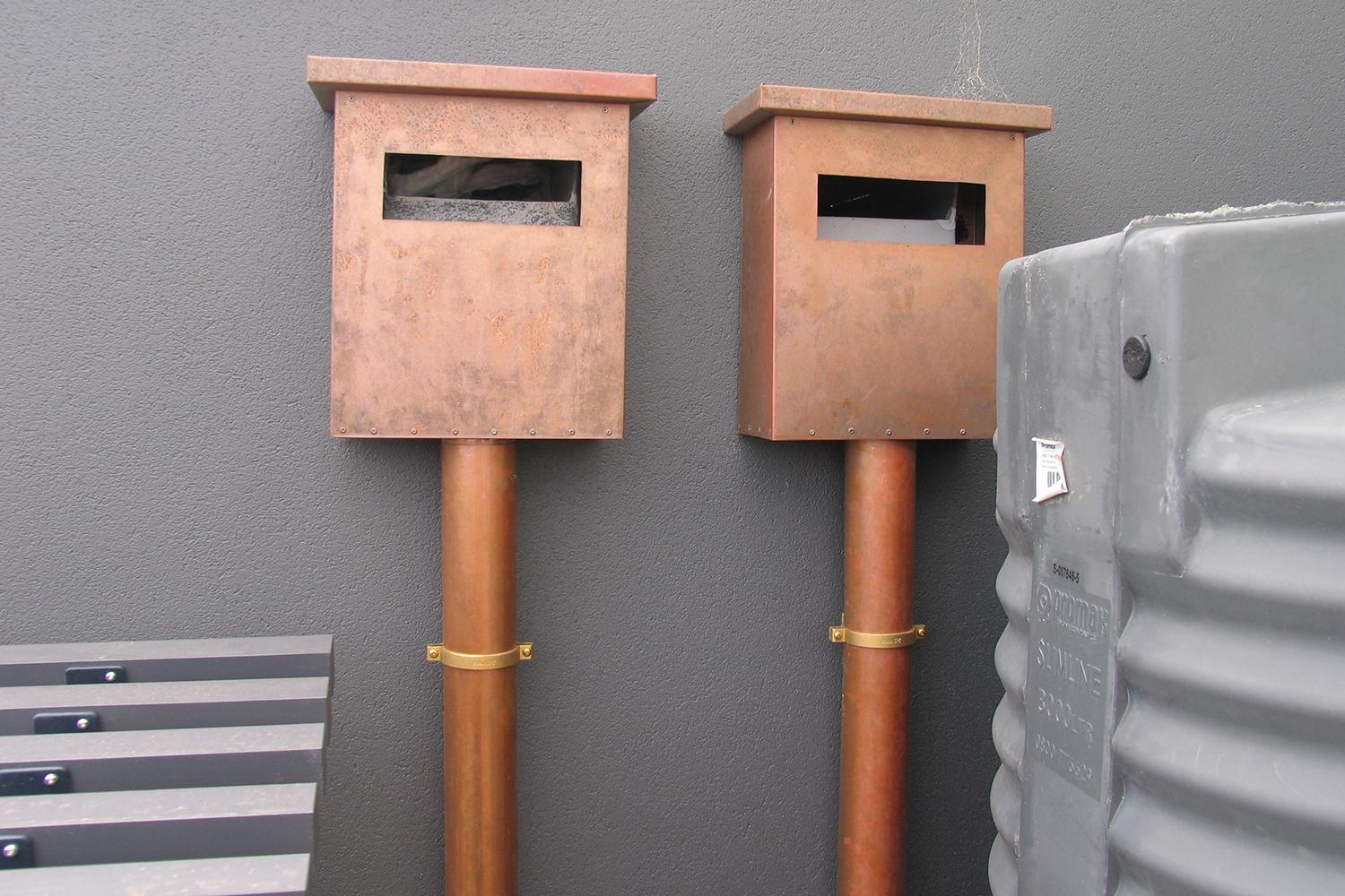 Copper rainheads with round copper downpipes