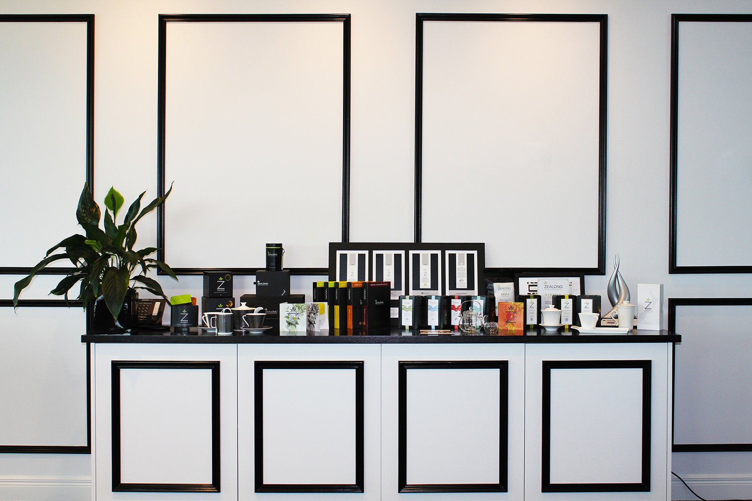 Zealong Tea Estate Retail store with their products displayed in front of a minimalistic black and white wall and cabinetry by Colourform Joinery