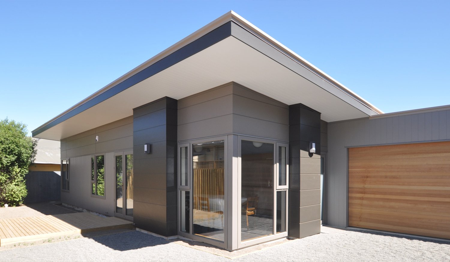 Modern grey, black and wooden house with grey uPVC window and door frames
