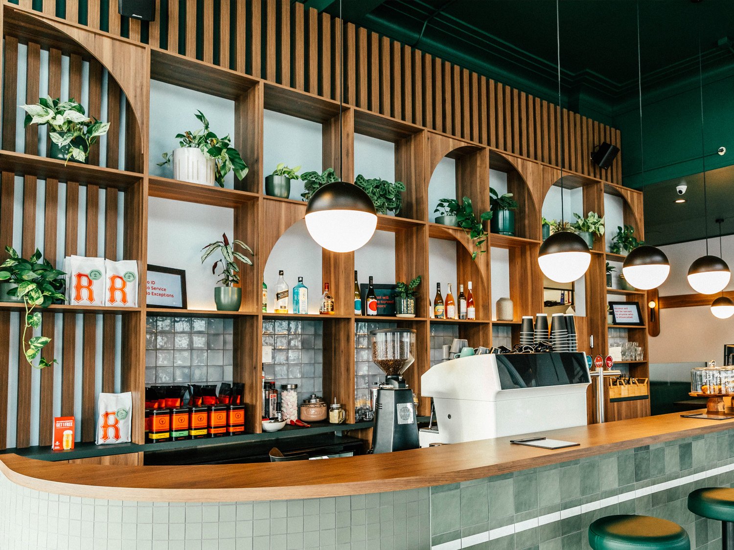 Hood street bistro's wall behind the register, designed beautifully and earthy with wood joinery and heaps of plants