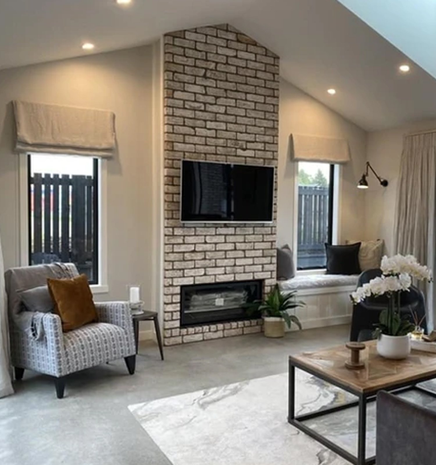 Residential interior with white walls and a white brick feature wall and cosy furnishings