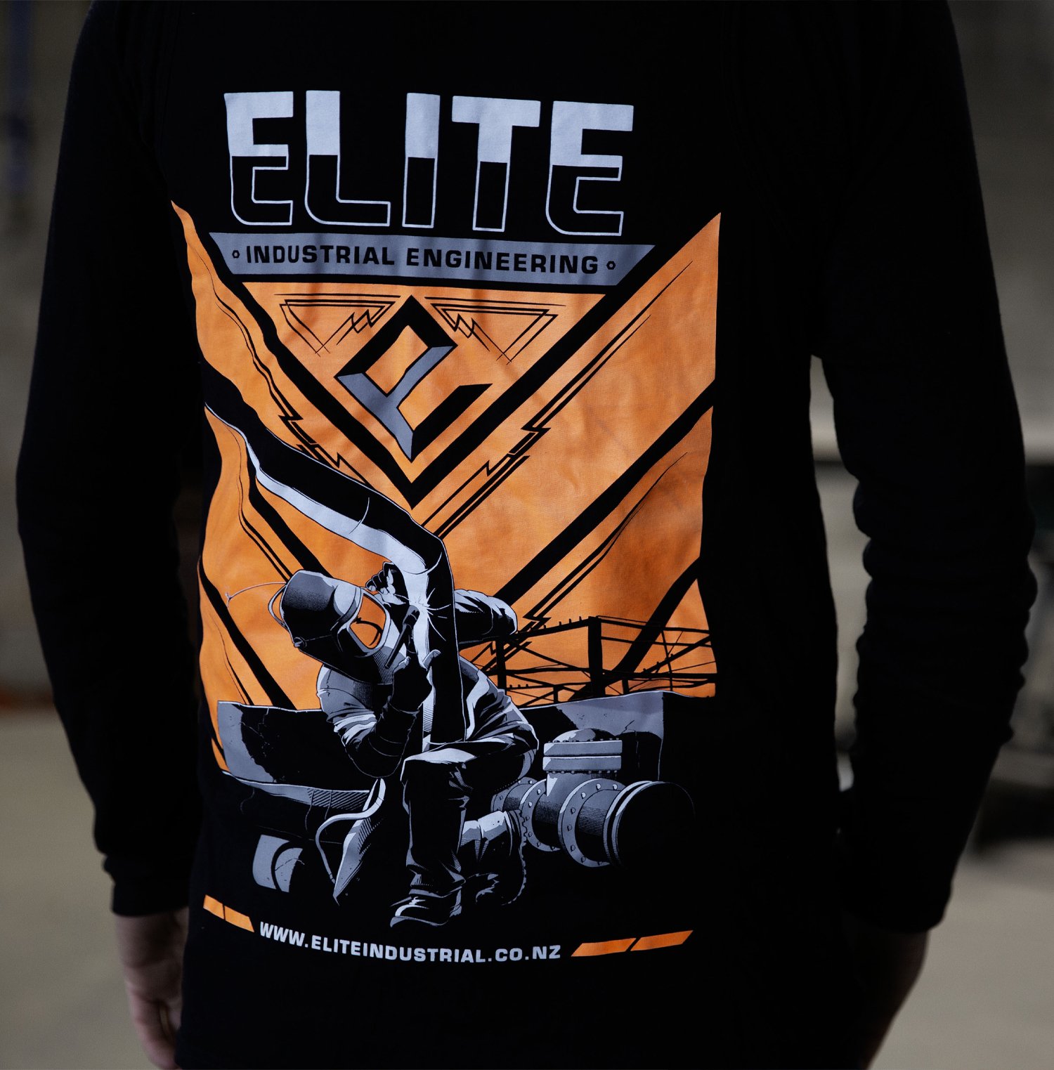 Elite Engineering logo graphic on the back of a long sleeve top a man is wearing