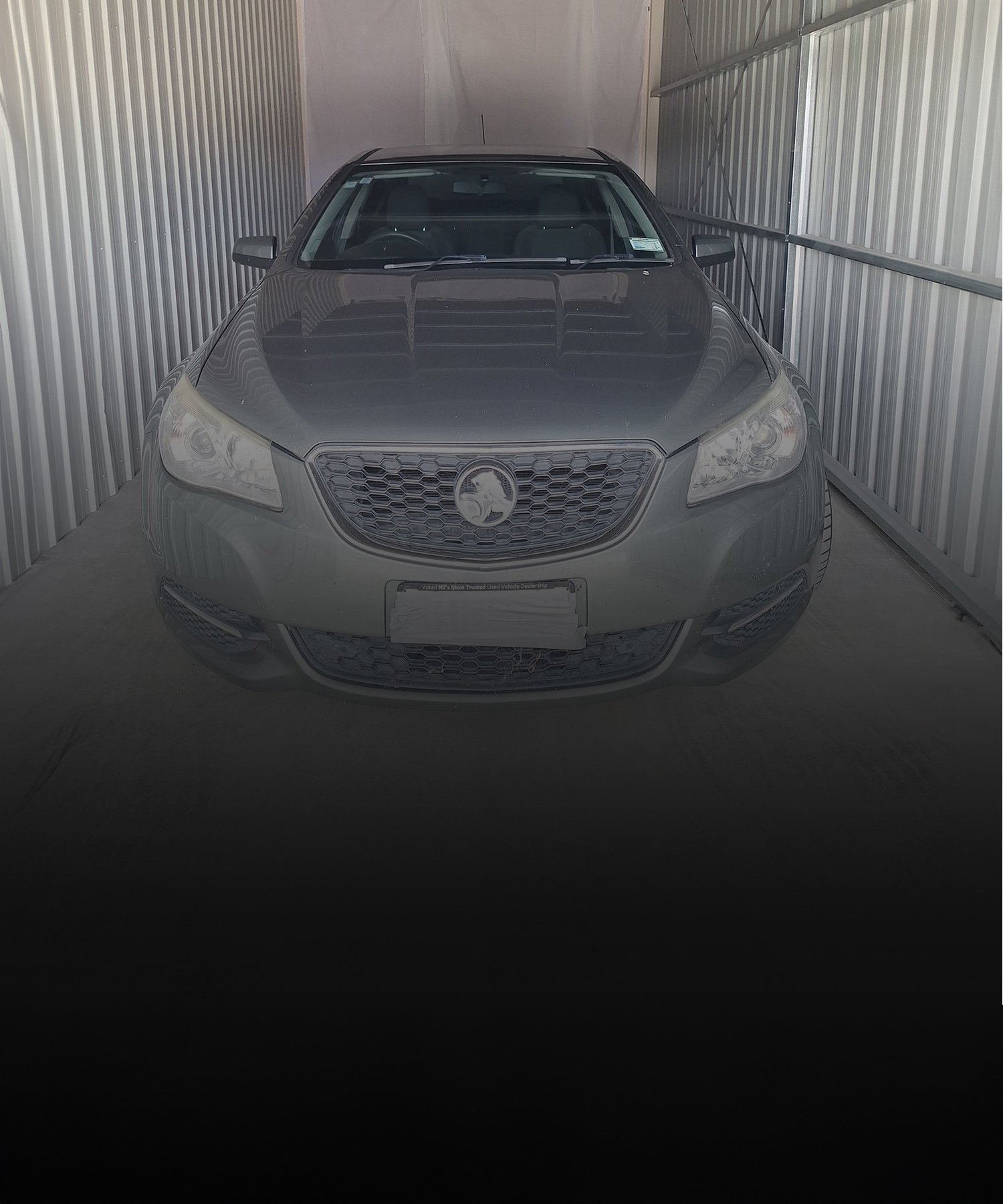 The front of a Silver Medium sized car parked inside one of the Storage Units | Links to the 'What We Do' page
