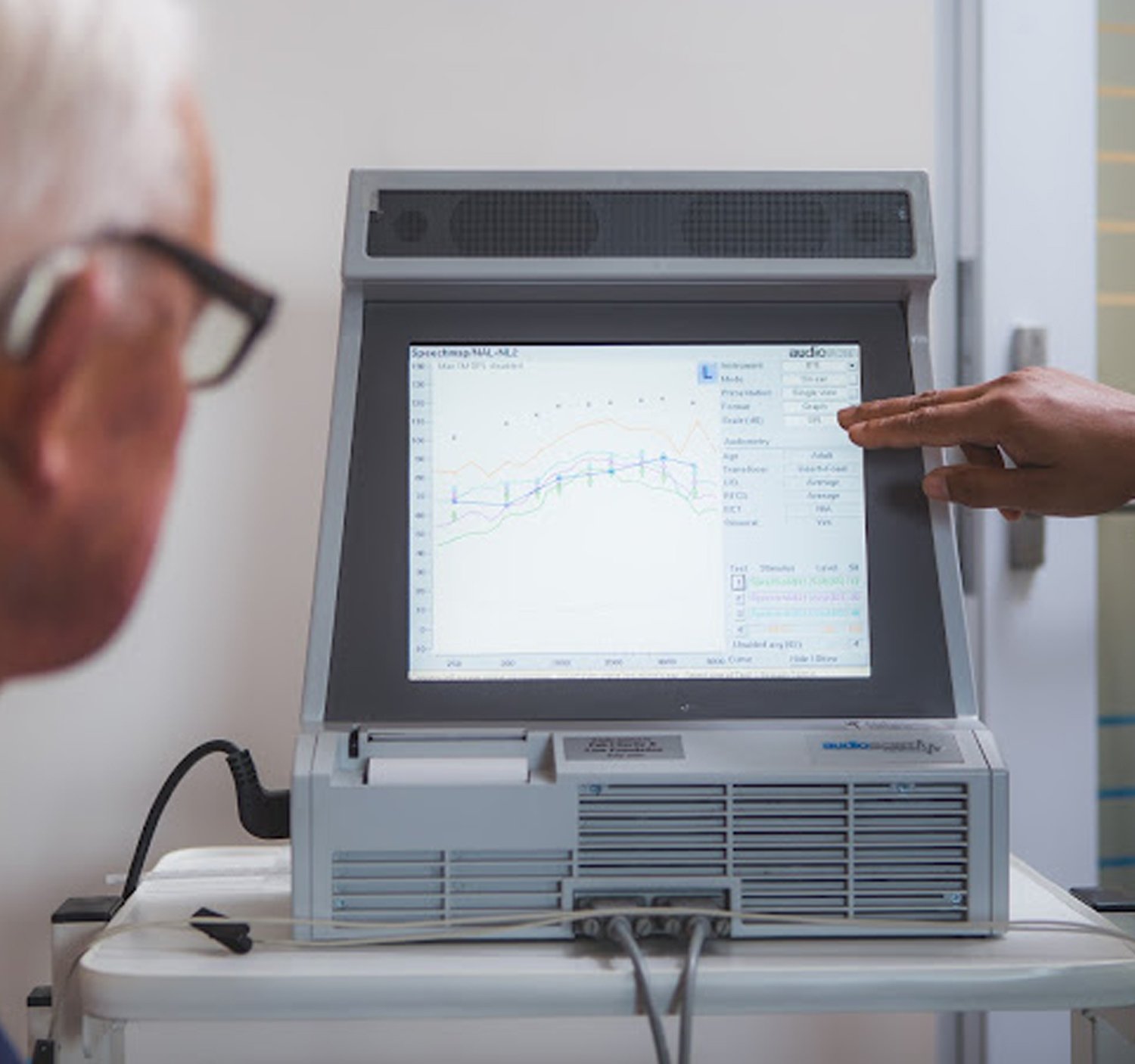 Audioligist explaining hearing test results to a client