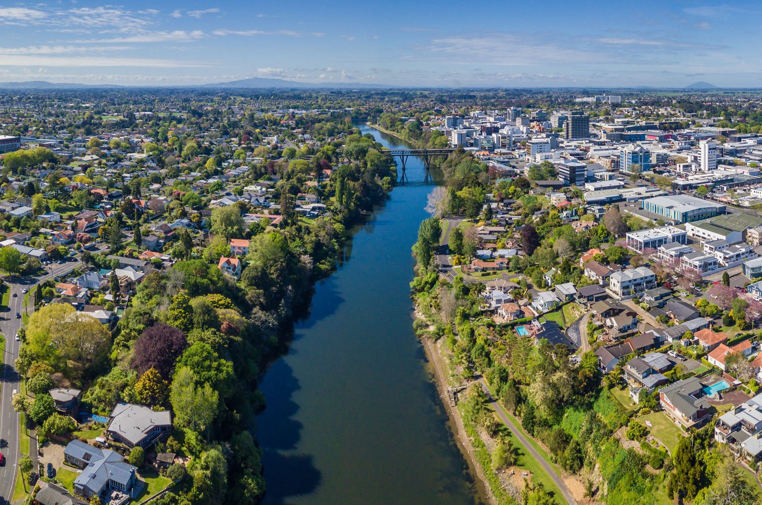 Entire town view from the sky that shows the Waikato river and all the surrounding properties