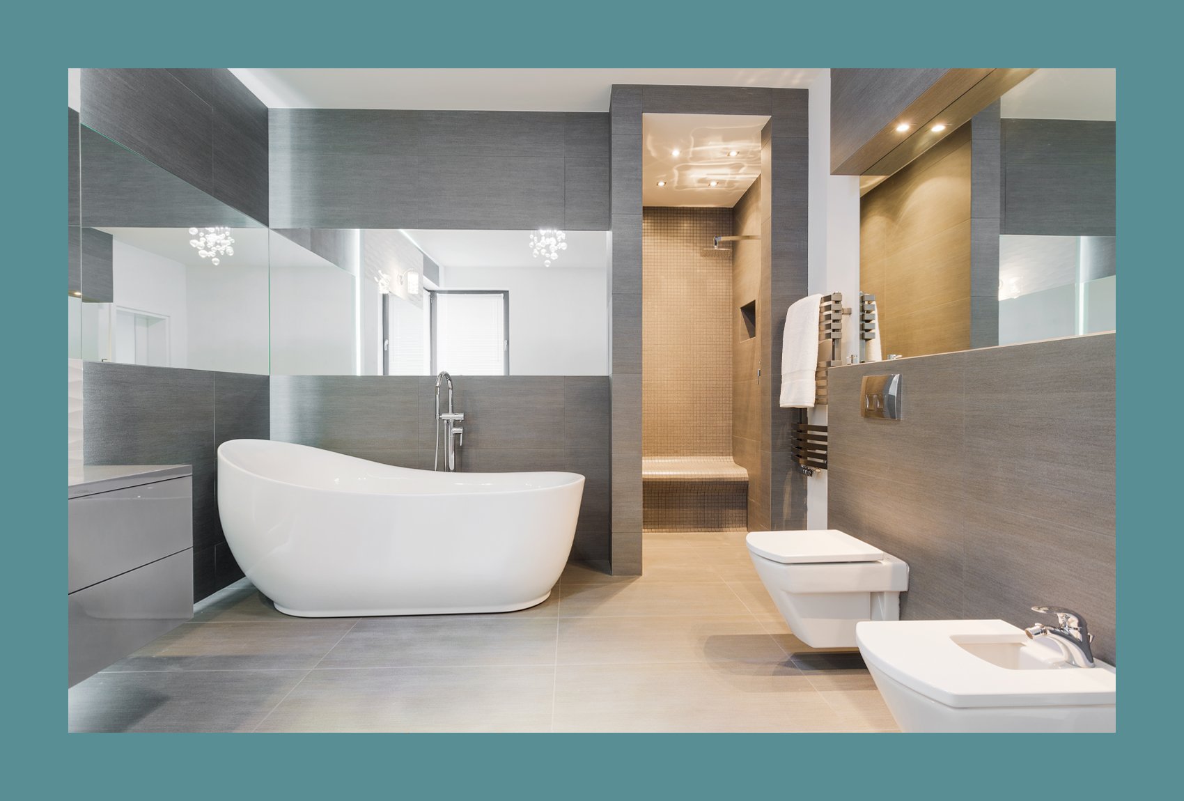 Custom designed bathroom with grey stone walls and a mirror that wraps around the whole room