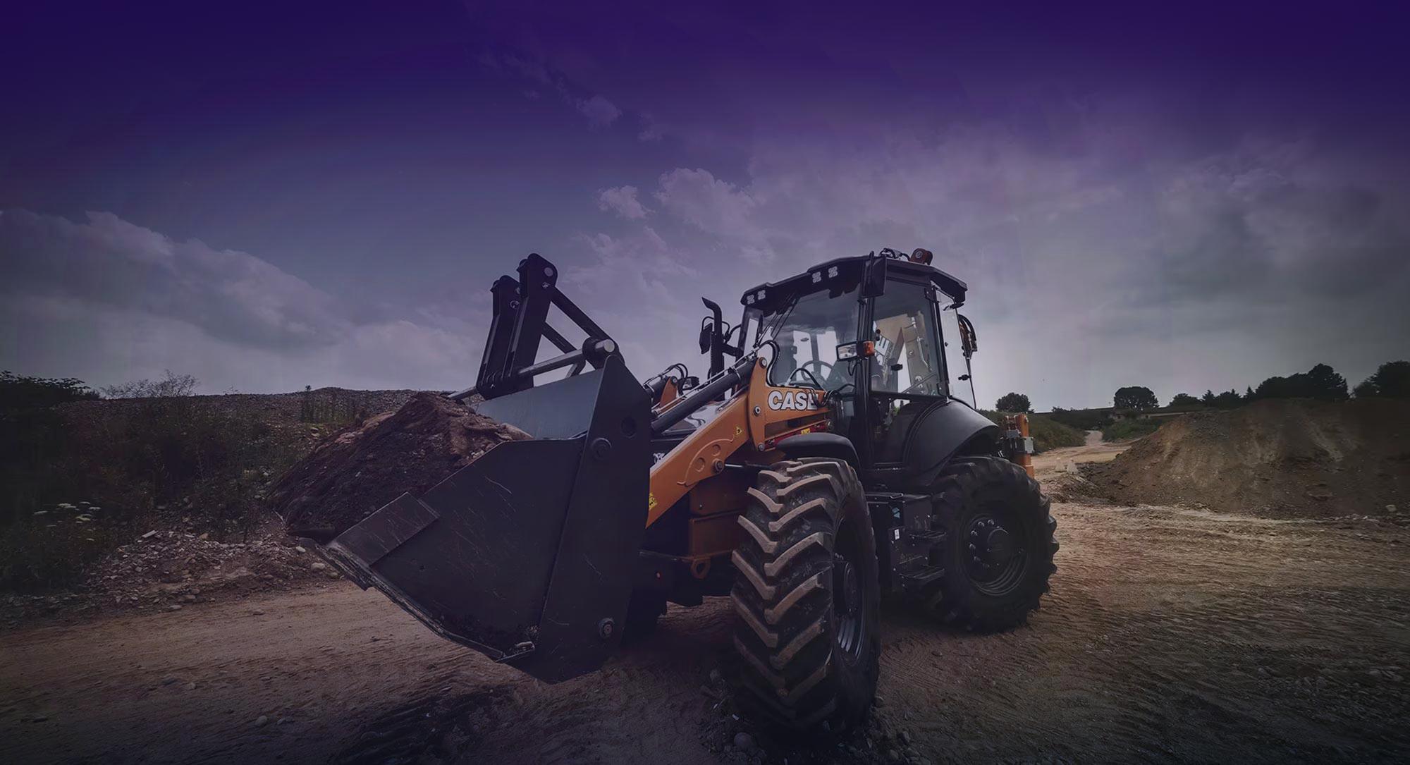 Large yellow excavator with a bucket full of dirt, moving the earth off the site