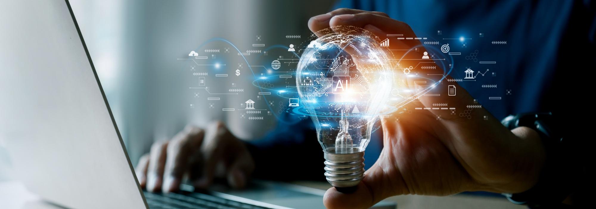 Man at a laptop, holding a lightbulb with the universe of AI and Tech in it in place of planets and stars