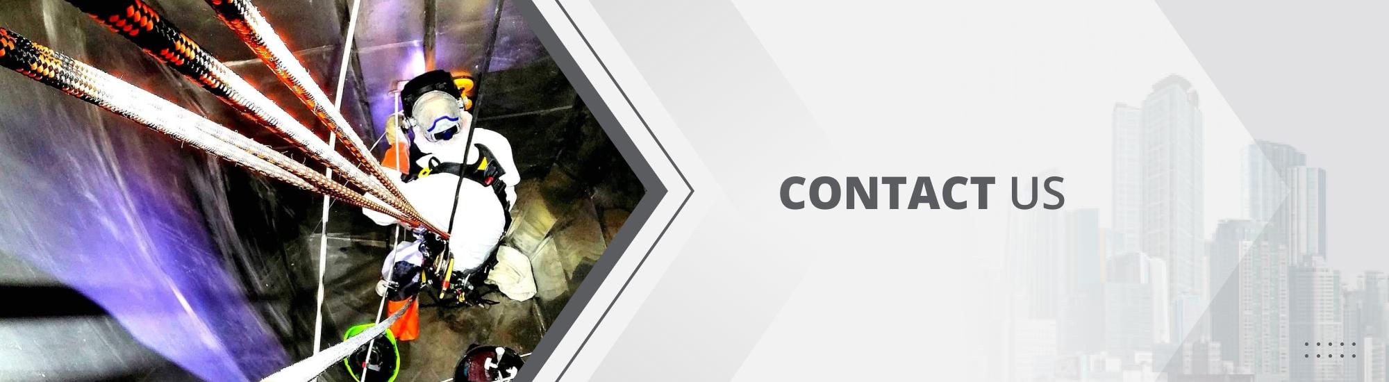 Expert abseiler rappelled down into a confined elevator space in a bright white jumpsuit and safety gear