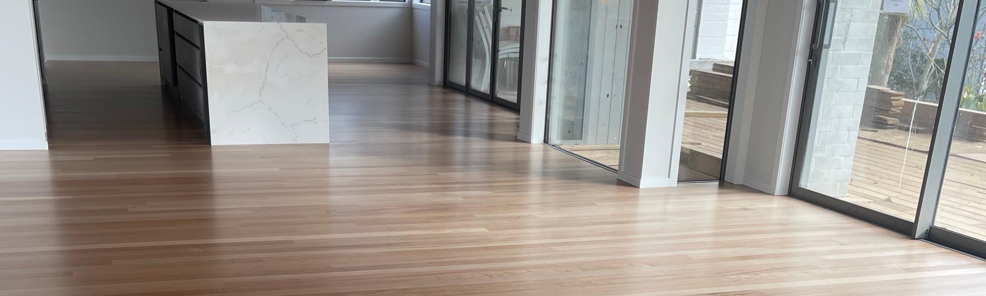 Residential home with a beautiful minimalistic kitchen with a marble island and newly finished timber floor