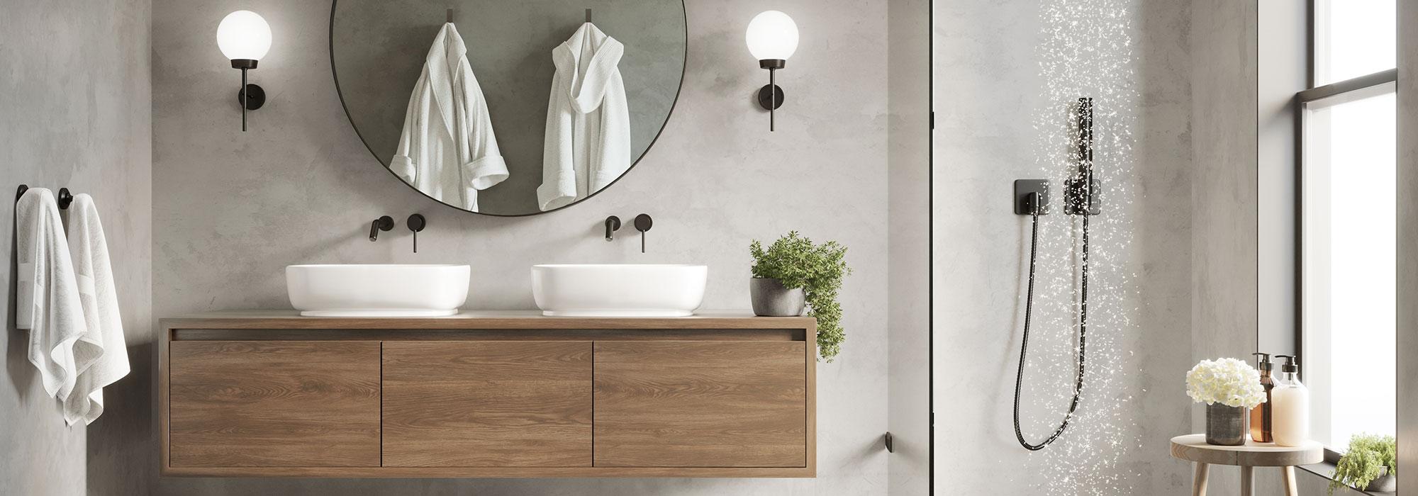Double sinks on a floating bathroom cabinet next to a large open shower with the water streaming down