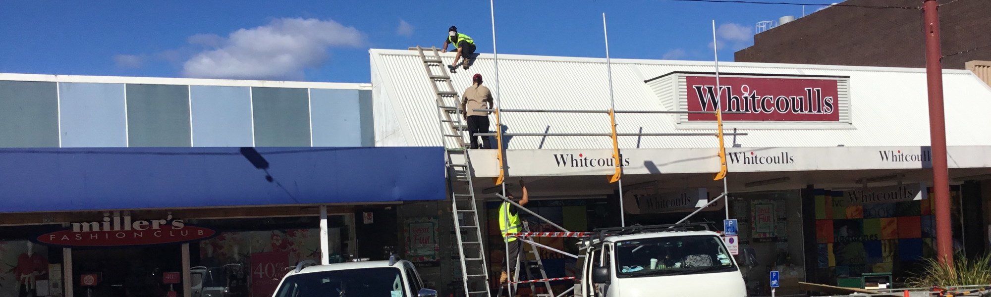 Team repairing retail soffit and roof