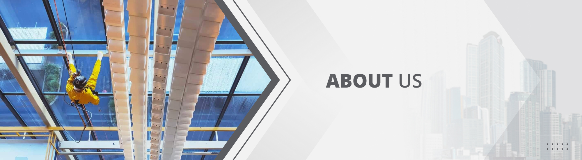 GR Abseiling team member rappelling on the interior wall of a factory with a complete wall of glass windows