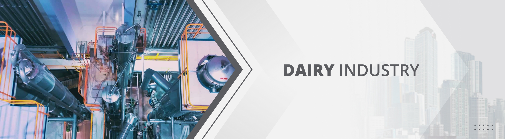 Several massive tall but thin cylinders in a dairy factory with a maze-like walkway and orange guide rails