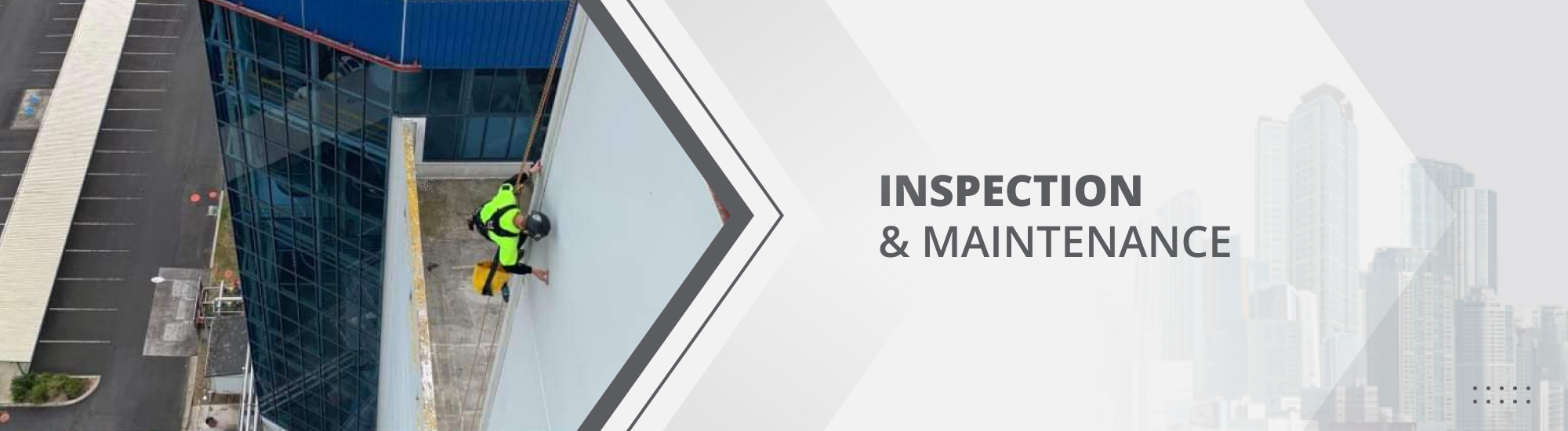 GR Abseiler rappelling down a Waikato commercial building checking for damage and inspecting the building's facade