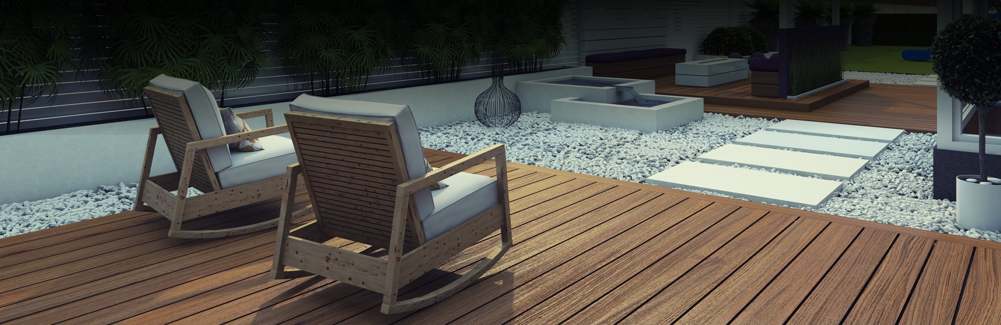 Two outdoor deck areas separated by a large pebble area with large white stone tiles to walk on between the two