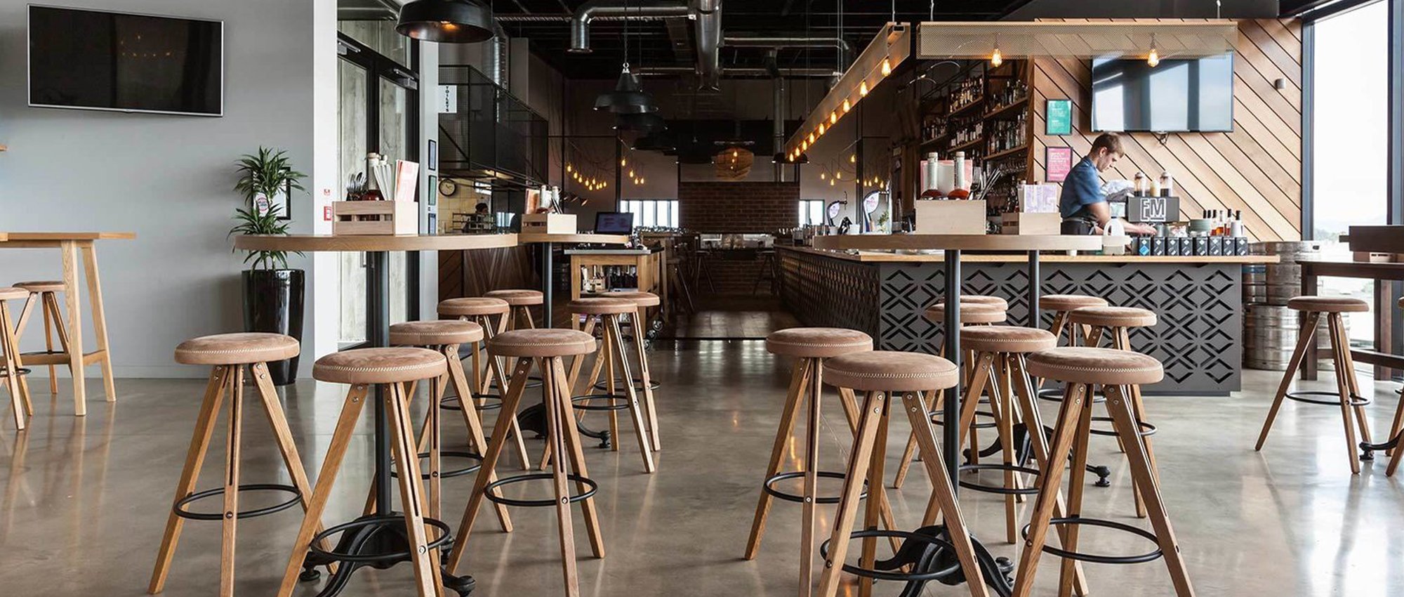 bar and restaurant space with custom wooden chairs, tabletops, benches and wall designs