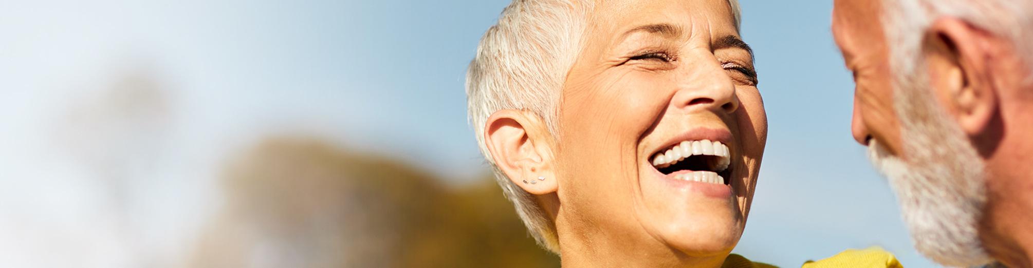 A senior woman laughing with her husband