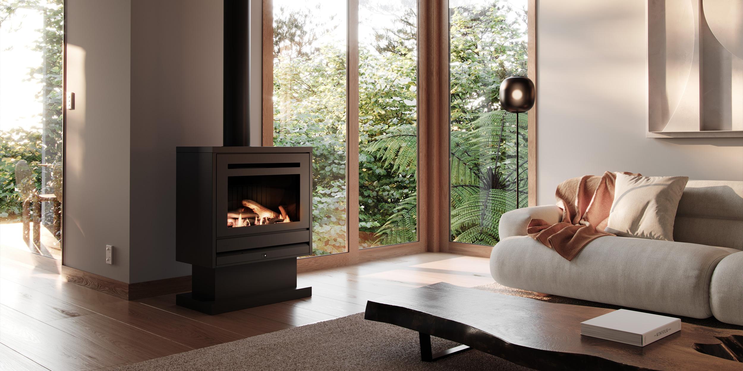 Freestanding wood fire in a living room with earthy tones and floor to ceiling windows that shows off the surrounding nature