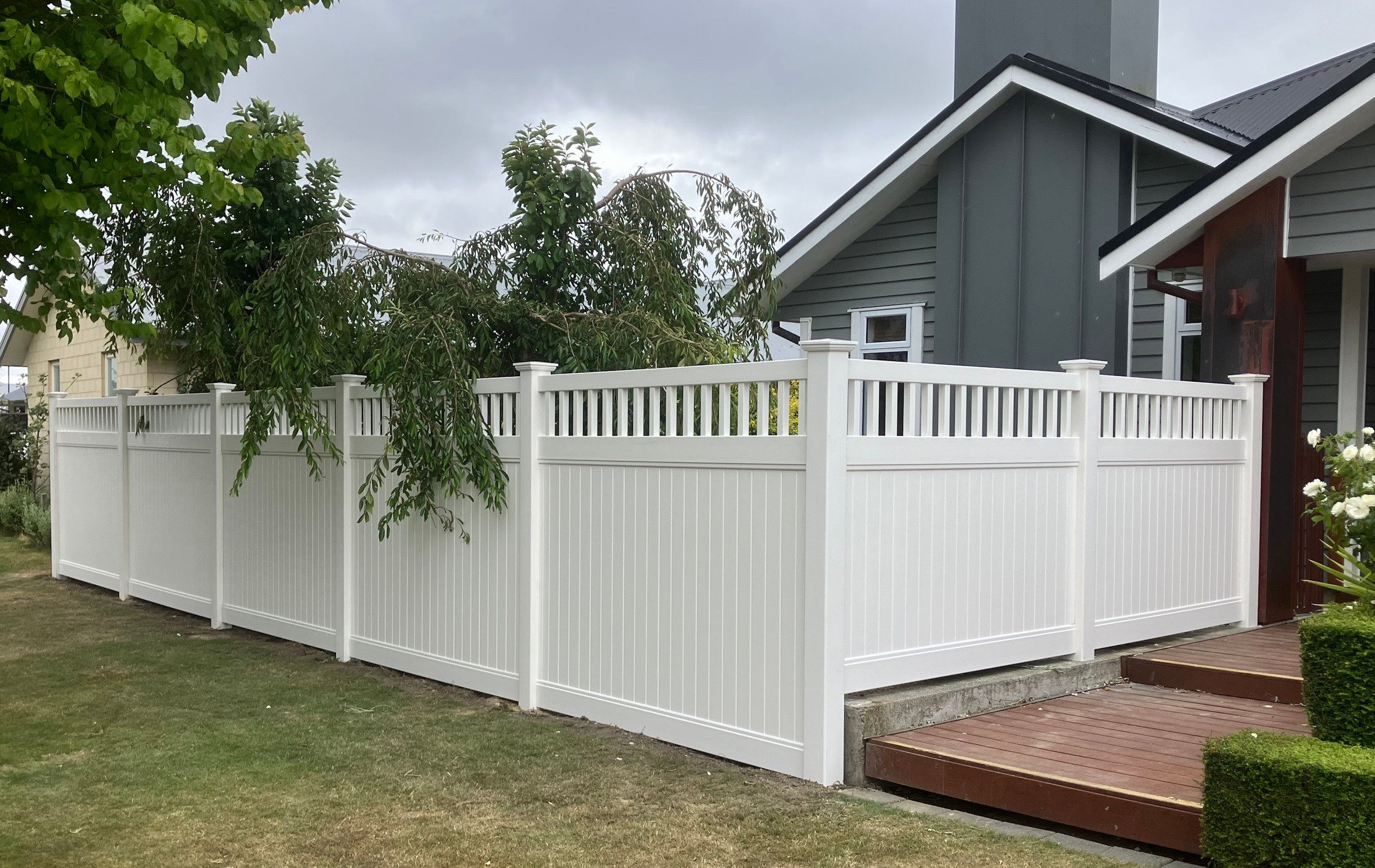 Fenced with Paragon fencing's white PVC fences, this creates a private area for this home's front yard next to the entrance
