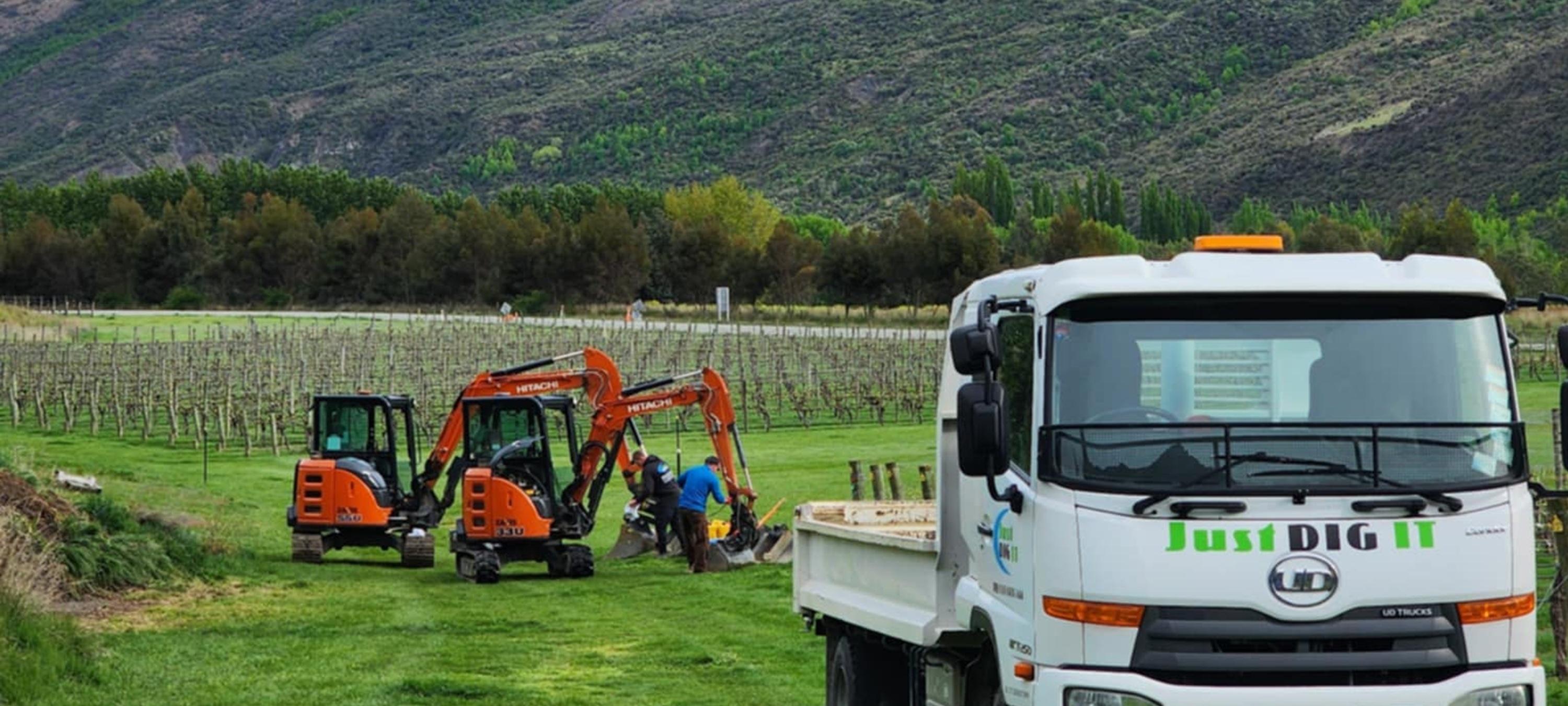 Just Dig It Truck and Excavators Working in a Vineyard
