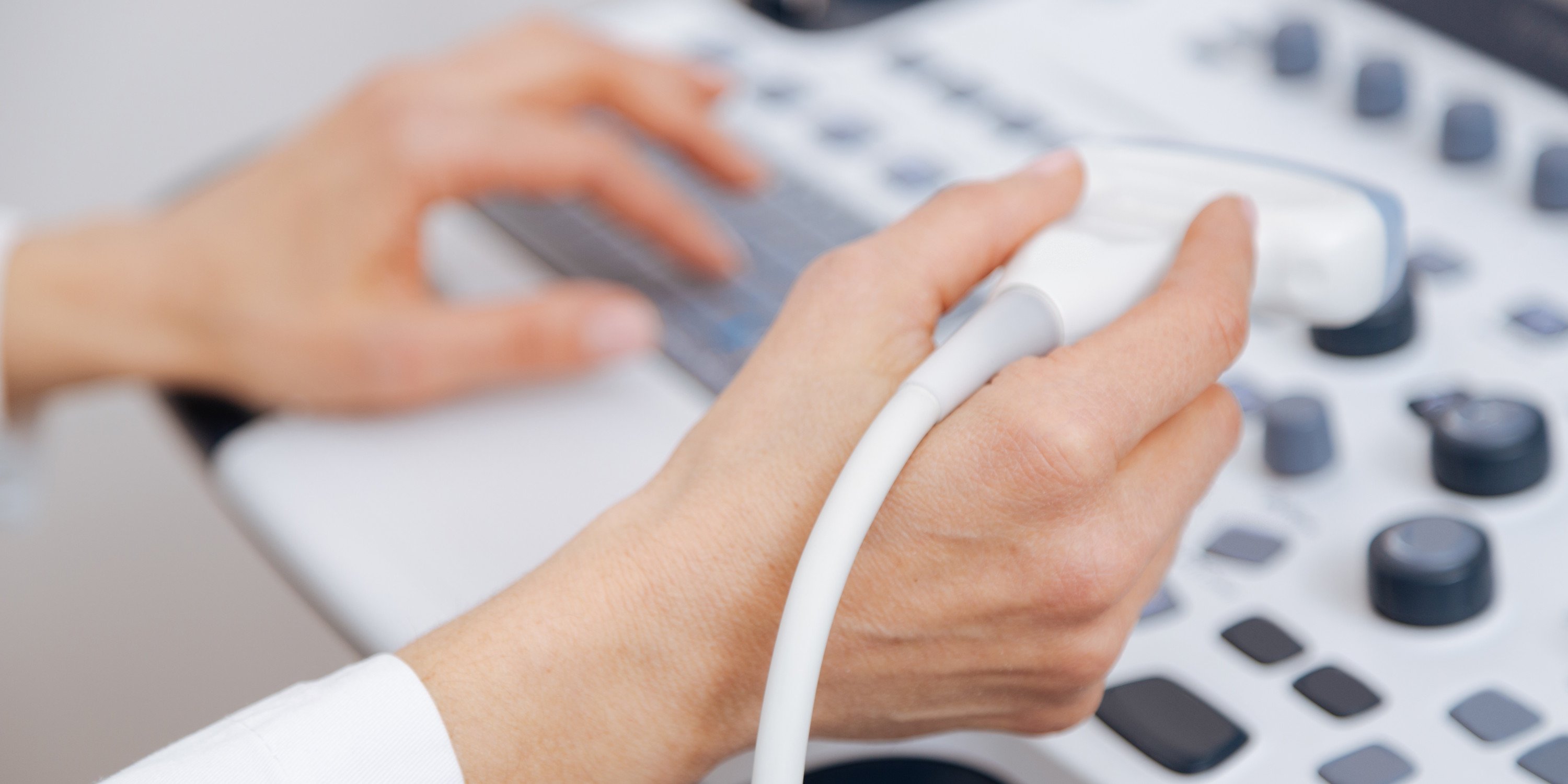 close up of hand with ultrasound transducer