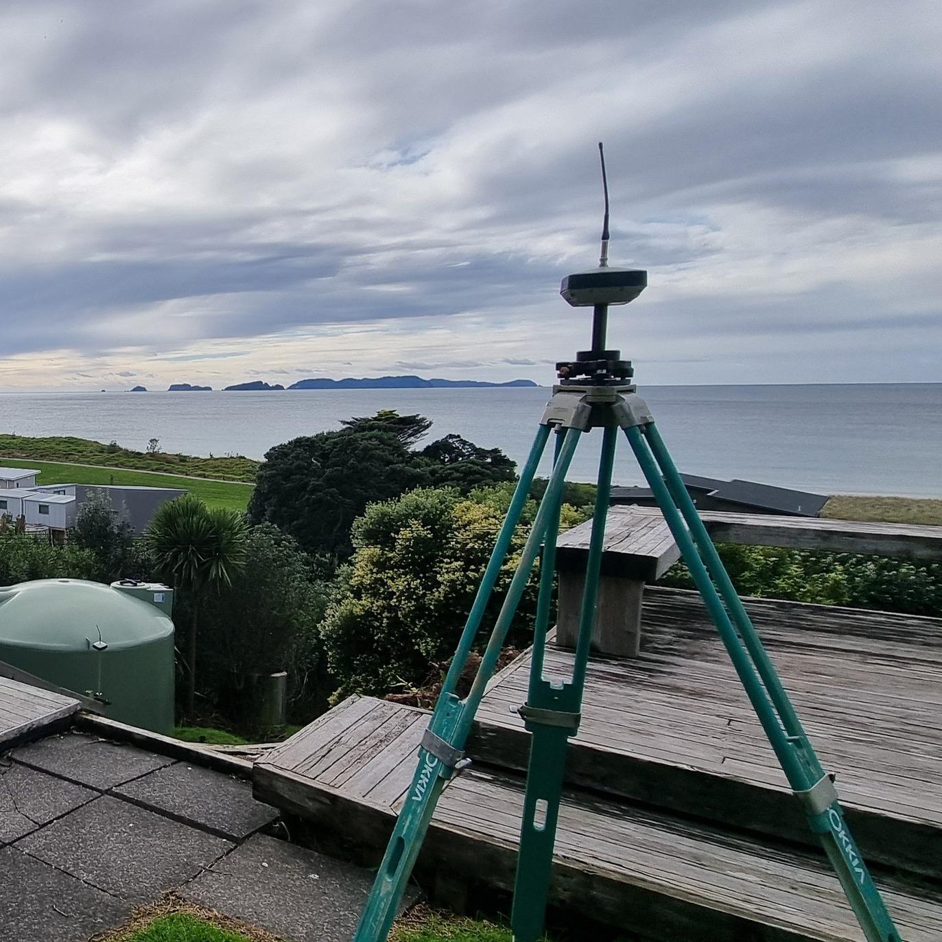 surveying equipment with a sea view in the background