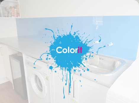 Small laundry room with a grey benchtop and royal blue reflective splashback