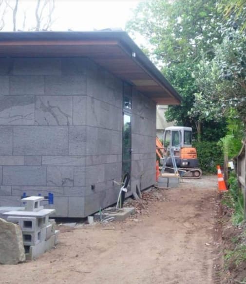 Newly built home with an excavated lawn ready for a driveway or new soil and grass